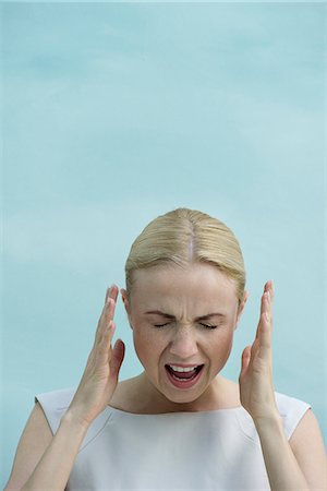 Woman shouting with eyes closed Stock Photo - Premium Royalty-Free, Code: 632-08331729