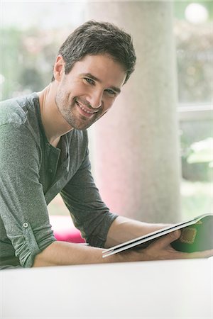 patience - Man looking through magazine while waiting in waiting room Stock Photo - Premium Royalty-Free, Code: 632-08545850