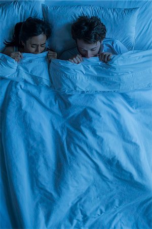 fear scared hiding - Couple lying together in bed scared Stock Photo - Premium Royalty-Free, Code: 632-08698344