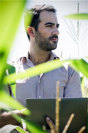 standing outside with laptop - Farmer using laptop computer while collecting data in cornfield Stock Photo - Premium Royalty-Free, Code: 632-08698583