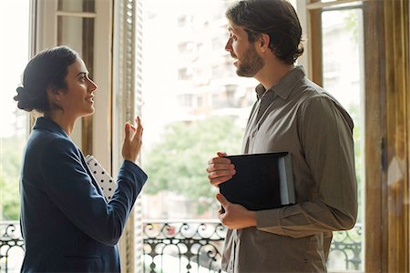 salesman talking to client - Realtor explaining features of home to prospective buyer Stock Photo - Premium Royalty-Free, Code: 632-08698621