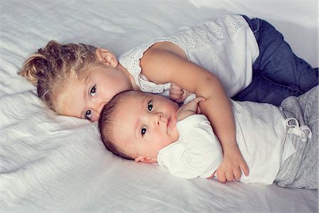 simsearch:632-05760167,k - Little girl cuddling with baby brother Stock Photo - Premium Royalty-Free, Code: 632-08698647
