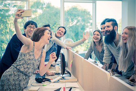 simsearch:632-08886351,k - Cheerful colleagues posing for a selfie in casual office Stock Photo - Premium Royalty-Free, Code: 632-08886350