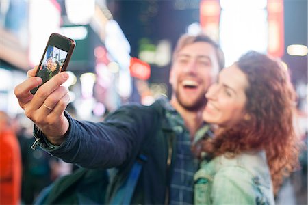 selfie night out - Young couple taking selfie in Times Square, New York City, New York, USA Stock Photo - Premium Royalty-Free, Code: 632-08886377