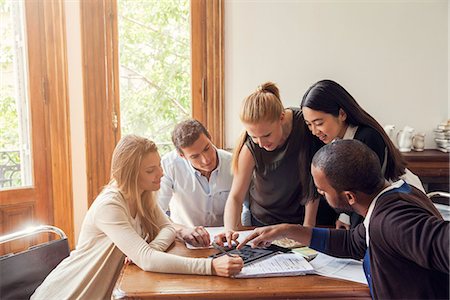 simsearch:632-08886369,k - Colleagues looking at digital tablet together in office Photographie de stock - Premium Libres de Droits, Code: 632-08886439