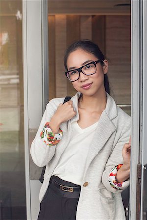 simsearch:632-08886905,k - Young woman standing in doorway, portrait Stock Photo - Premium Royalty-Free, Code: 632-08886468