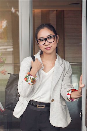 simsearch:632-08886905,k - Young woman standing in doorway, portrait Stock Photo - Premium Royalty-Free, Code: 632-08886469