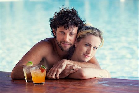 simsearch:632-08129776,k - Couple relaxing together in pool with cocktails Stock Photo - Premium Royalty-Free, Code: 632-08886584