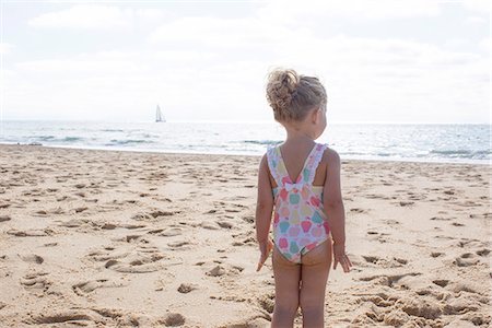 picture little girl swimming suit - Little girl staring at the sea Stock Photo - Premium Royalty-Free, Code: 632-08886854