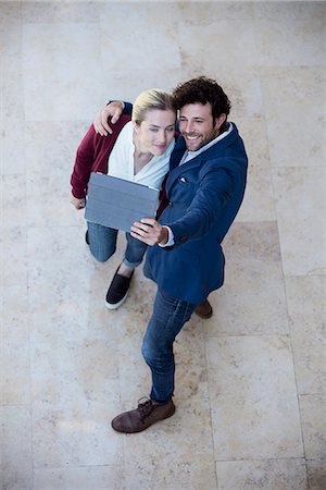 Couple using digital tablet to take a selfie Stock Photo - Premium Royalty-Free, Code: 632-08886897