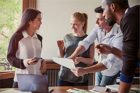 Colleagues collaborating on project in office Stock Photo - Premium Royalty-Free, Code: 632-08886925