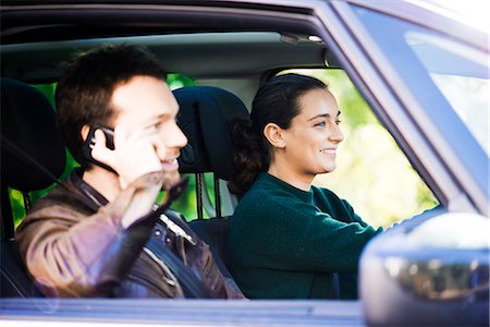 simsearch:633-08639079,k - Woman driving while passenger chats on phone Stock Photo - Premium Royalty-Free, Code: 632-08886945