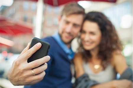 Man using smartphone to photgraph himself with his wife Stock Photo - Premium Royalty-Free, Code: 632-08886990