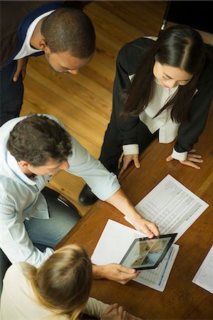 Colleagues using digital tablet during meeting Stock Photo - Premium Royalty-Free, Code: 632-08887043