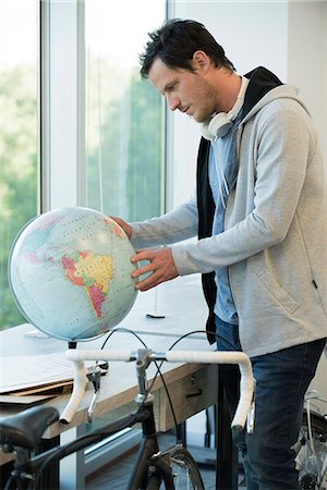 student travel - Man looking at globe Stock Photo - Premium Royalty-Free, Code: 632-08887112