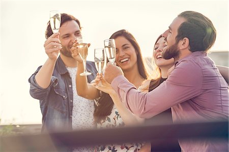 Friends drinking champagne together outdoors Stock Photo - Premium Royalty-Free, Code: 632-08993424