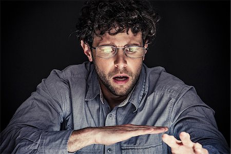 digital tablet and shocked and one person - Man looking down with shocked expression on face Stock Photo - Premium Royalty-Free, Code: 632-08993608