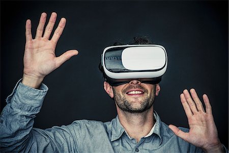 Man using virtual reality simulator Stock Photo - Premium Royalty-Free, Code: 632-08993611