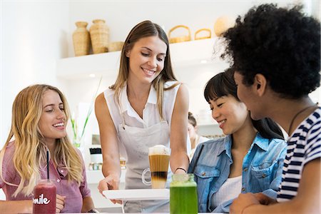 simsearch:6126-09104476,k - Young women having drinks together in cafe Stock Photo - Premium Royalty-Free, Code: 632-08993696