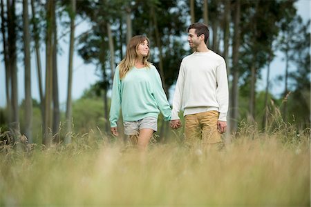Young couple walking hand in hand through tall grass Stock Photo - Premium Royalty-Free, Code: 632-09021436