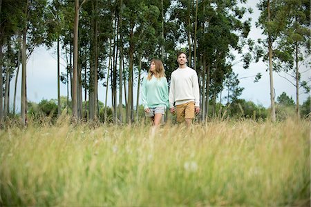 Couple walking though tall grass together Stock Photo - Premium Royalty-Free, Code: 632-09021437