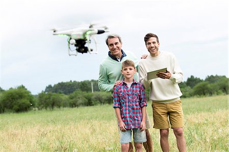 flying mid air - Family playing with drone in field Stock Photo - Premium Royalty-Free, Code: 632-09021574