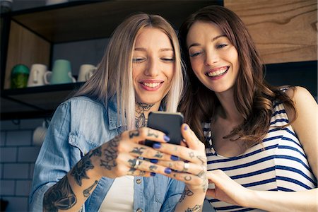 simsearch:632-09039785,k - Women looking at smartphone together Stock Photo - Premium Royalty-Free, Code: 632-09039718