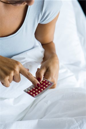 pilule contraceptive - Woman holding birth control pills Photographie de stock - Premium Libres de Droits, Code: 632-09039902