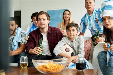 football fan on couch - Argentinian football fans watching football match at home Stock Photo - Premium Royalty-Free, Code: 632-09130166