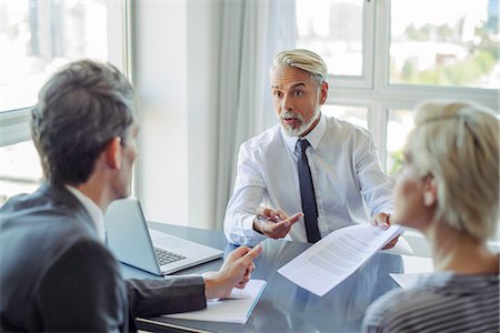 financial advisor talking with clients - Business professionals negotiating Stock Photo - Premium Royalty-Free, Code: 632-09140181