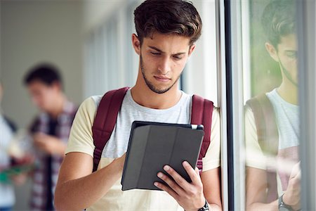 simsearch:695-05763398,k - Male college student using digital tablet in corridor Stock Photo - Premium Royalty-Free, Code: 632-09158065