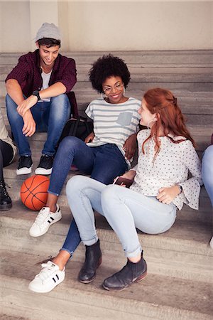 students sitting on bleachers - Friends hanging out after school Stock Photo - Premium Royalty-Free, Code: 632-09158107