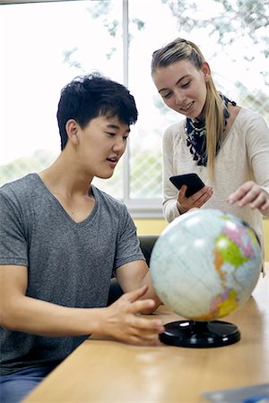 Students looking at globe in class Stock Photo - Premium Royalty-Free, Code: 632-09158125