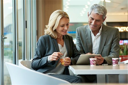 Businesspeople using digital tablet in cafeteria Stock Photo - Premium Royalty-Free, Code: 632-09162645