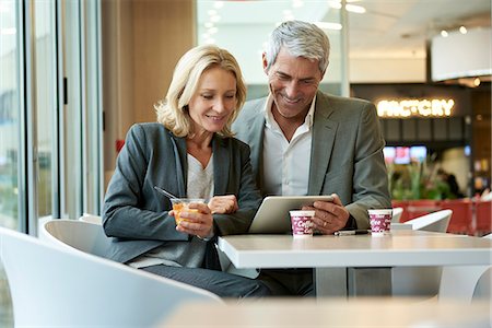 Businesspeople using digital tablet in cafeteria Stock Photo - Premium Royalty-Free, Code: 632-09162647