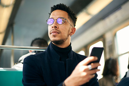 smartphone train - Thoughtful businessman with smartphone Stock Photo - Premium Royalty-Free, Code: 632-09192308