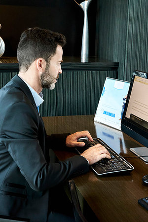 formal mouse computer - Businessman working on computer in hotel Photographie de stock - Premium Libres de Droits, Code: 632-09254546