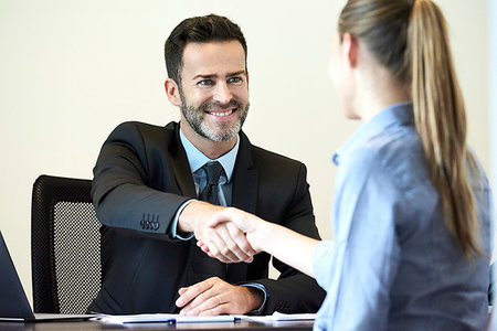 simsearch:6109-08203160,k - Businessman shaking hands with businesswoman in office Stock Photo - Premium Royalty-Free, Code: 632-09254688