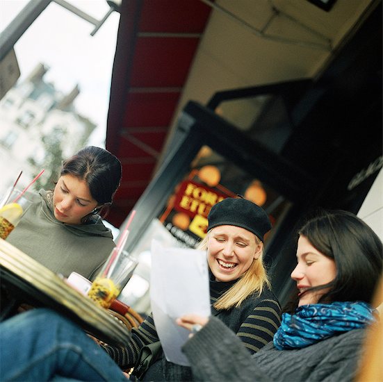 Three teenage girls sitting at cafe terrace, tilt Stock Photo - Premium Royalty-Free, Image code: 632-01137075