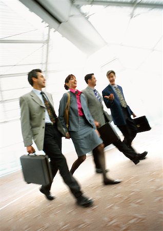 Group of business people walking together indoors, blurred. Stock Photo - Premium Royalty-Free, Code: 632-01138227