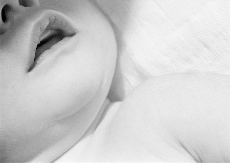 fat laying down - Baby's lower face and shoulder, close-up, b&w Stock Photo - Premium Royalty-Free, Code: 632-01139875