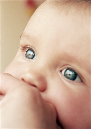 Baby's face and adult hand, close-up Stock Photo - Premium Royalty-Free, Code: 632-01139934