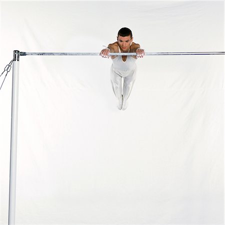 simsearch:632-05760558,k - Male gymnast swinging on horizontal bar Foto de stock - Sin royalties Premium, Código: 632-01145049