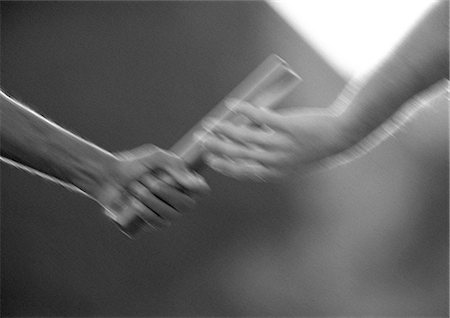 Male athletes passing relay baton, blurred motion, close-up, b&w Stock Photo - Premium Royalty-Free, Code: 632-01145090