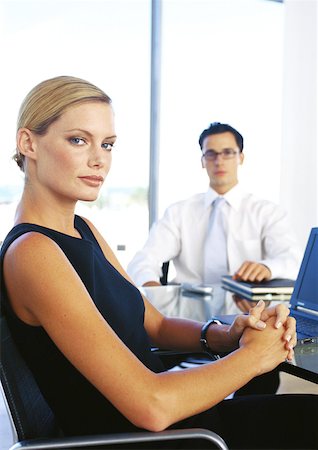 Businessman and woman sitting in office, portrait Stock Photo - Premium Royalty-Free, Code: 632-01146152
