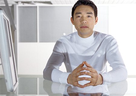 Man sitting at desk, portrait Stock Photo - Premium Royalty-Free, Code: 632-01146182