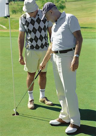 Two mature golfers looking at hole Stock Photo - Premium Royalty-Free, Code: 632-01146672