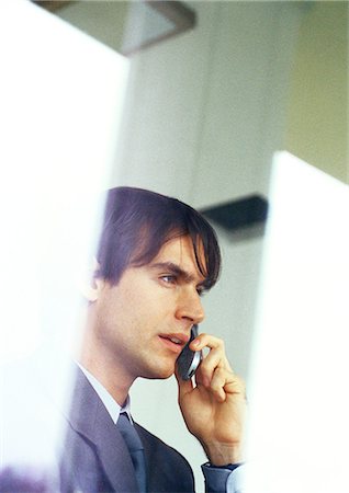 simsearch:632-08130262,k - Businessman talking on cell phone, partial view, head and shoulders Stock Photo - Premium Royalty-Free, Code: 632-01147867