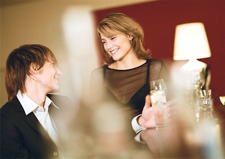 simsearch:632-01148261,k - Young man and woman at bar, smiling Stock Photo - Premium Royalty-Free, Code: 632-01147888