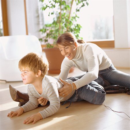 family tickling - Mother grasping son, on floor Stock Photo - Premium Royalty-Free, Code: 632-01147932